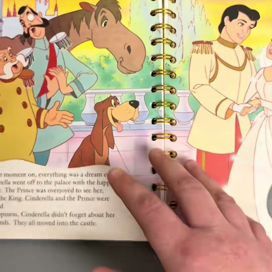 Open Cinderella spiral journal showing original story illustrations and gold wire binding